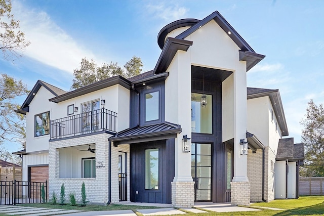 view of front of property with a front yard and a balcony