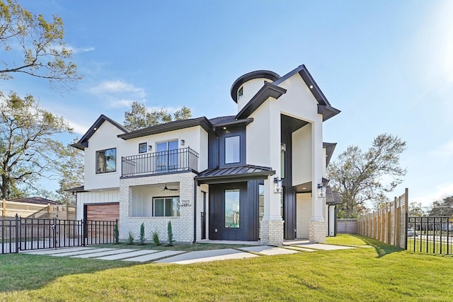 rear view of property featuring a lawn, a balcony, and a garage