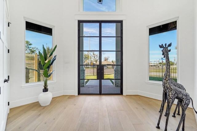 entryway featuring french doors and light hardwood / wood-style flooring