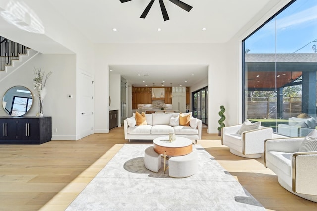 living room with ceiling fan and light hardwood / wood-style floors