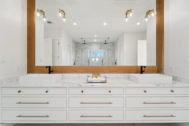 bathroom featuring vanity and tiled shower