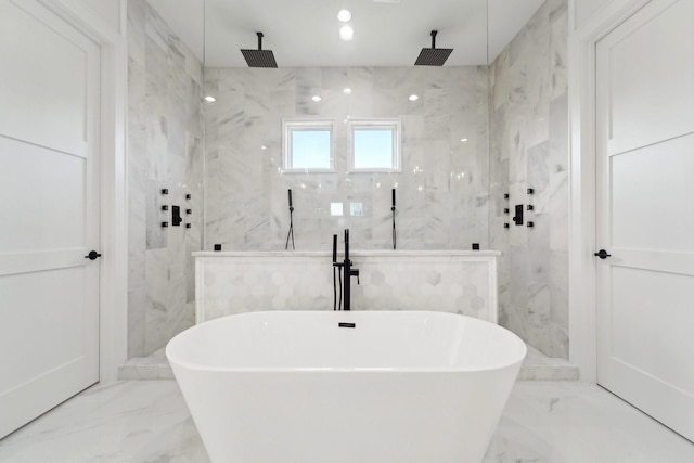 bathroom with shower with separate bathtub and tile walls