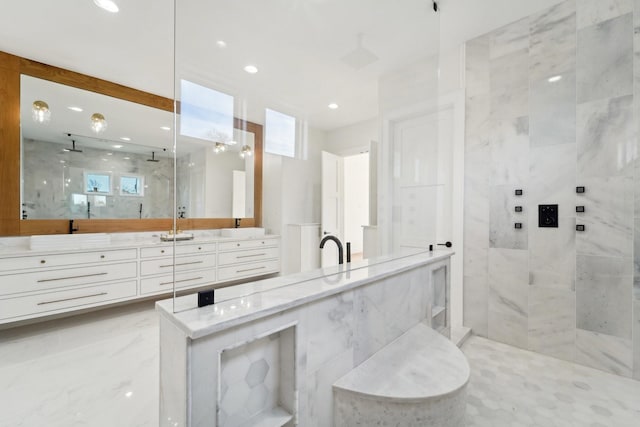 bathroom with vanity and tiled shower