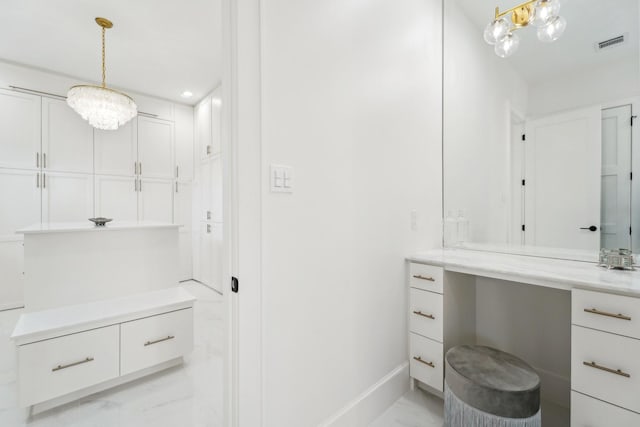 bathroom featuring vanity and a chandelier