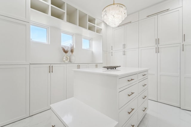 walk in closet featuring a chandelier