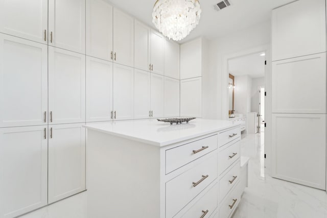 walk in closet with a chandelier