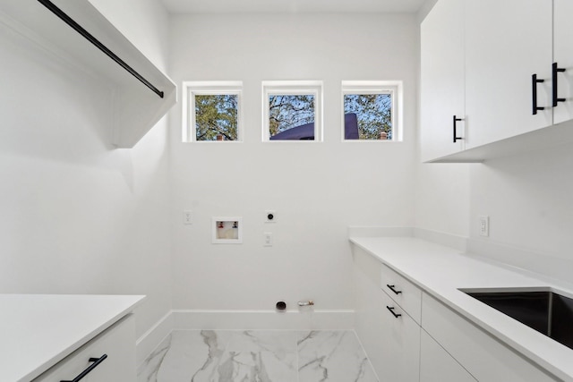 washroom with electric dryer hookup, hookup for a washing machine, cabinets, and hookup for a gas dryer