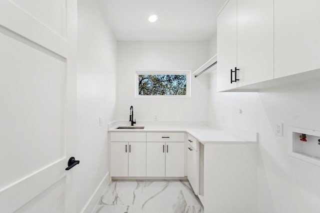 laundry area with sink, cabinets, and hookup for a washing machine