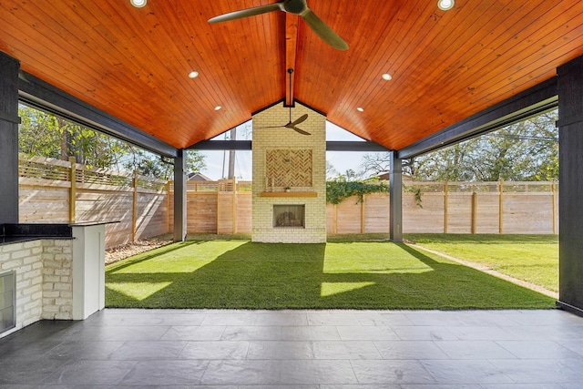 unfurnished sunroom with an outdoor brick fireplace, ceiling fan, lofted ceiling with beams, and wooden ceiling