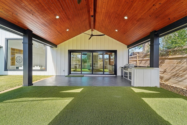 exterior space featuring an outdoor kitchen and ceiling fan