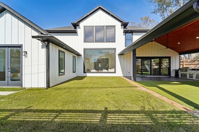 rear view of house featuring a yard and ceiling fan