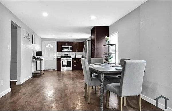 dining space with dark wood-type flooring