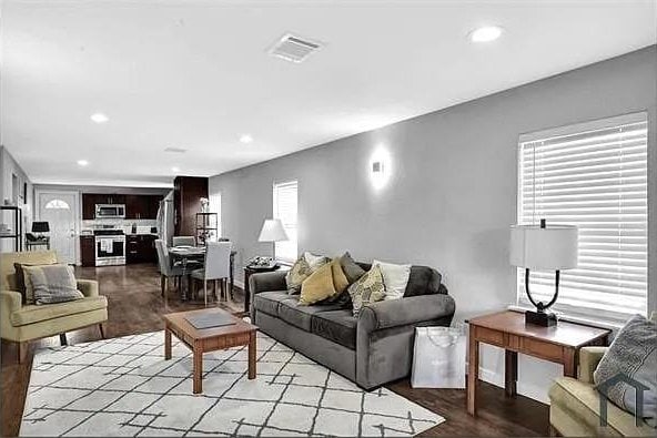 living room featuring light hardwood / wood-style flooring and a healthy amount of sunlight