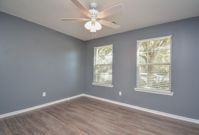 spare room with ceiling fan and dark hardwood / wood-style flooring