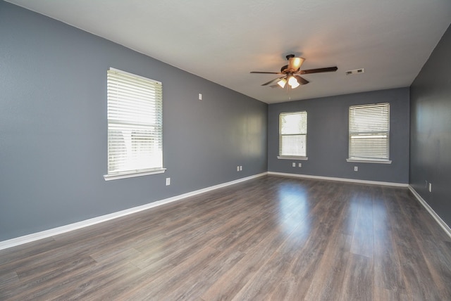 unfurnished room with ceiling fan and dark hardwood / wood-style floors