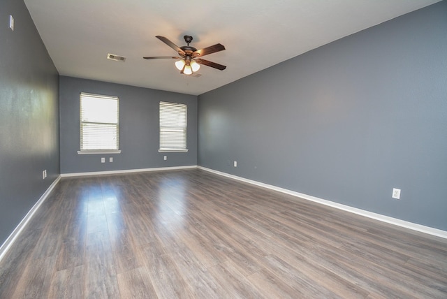 unfurnished room featuring ceiling fan and dark hardwood / wood-style flooring