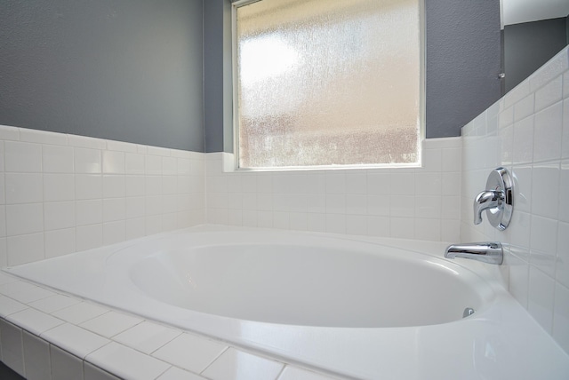 bathroom with tiled bath