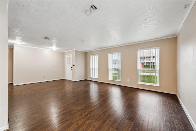 spare room featuring a textured ceiling, dark hardwood / wood-style flooring, and crown molding