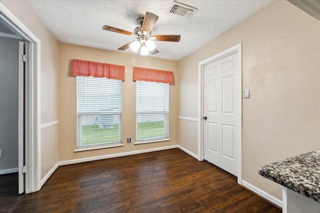 dining area with dark hardwood / wood-style flooring, a textured ceiling, and ceiling fan