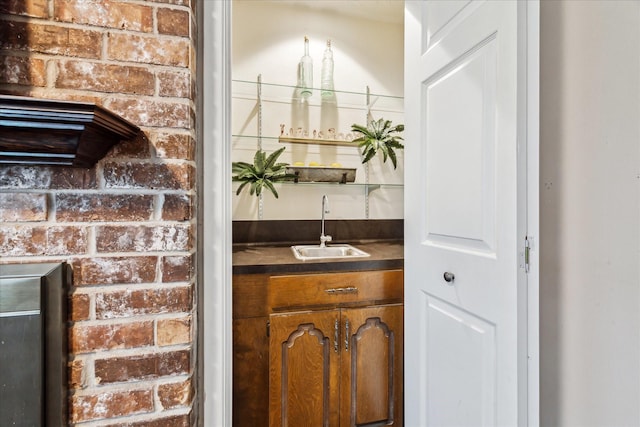 bar featuring brick wall and sink