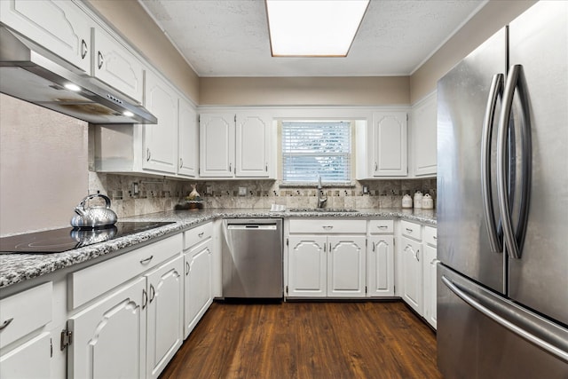 kitchen with white cabinets, stainless steel appliances, backsplash, and sink