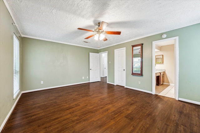 unfurnished bedroom with ceiling fan, connected bathroom, ornamental molding, and hardwood / wood-style flooring