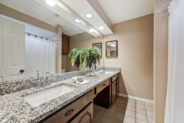 bathroom with vanity, tile patterned flooring, and toilet