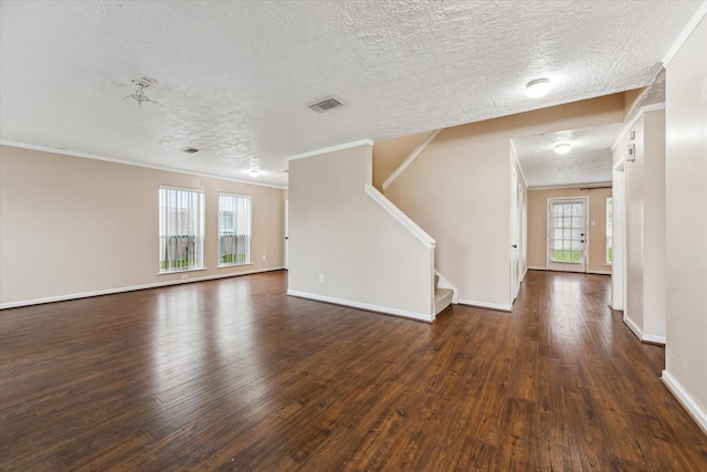 unfurnished living room with dark hardwood / wood-style flooring, plenty of natural light, and crown molding