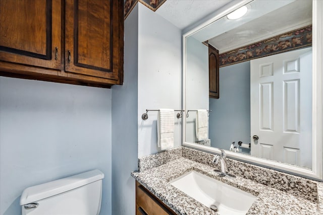 bathroom with toilet and vanity