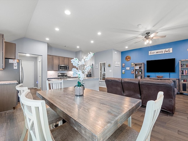 dining space with ceiling fan, vaulted ceiling, wood finished floors, and recessed lighting