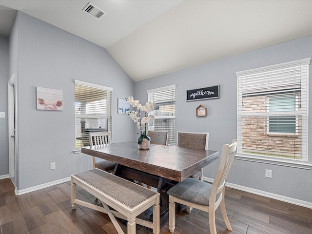 dining area with dark wood-style floors, lofted ceiling, visible vents, and baseboards