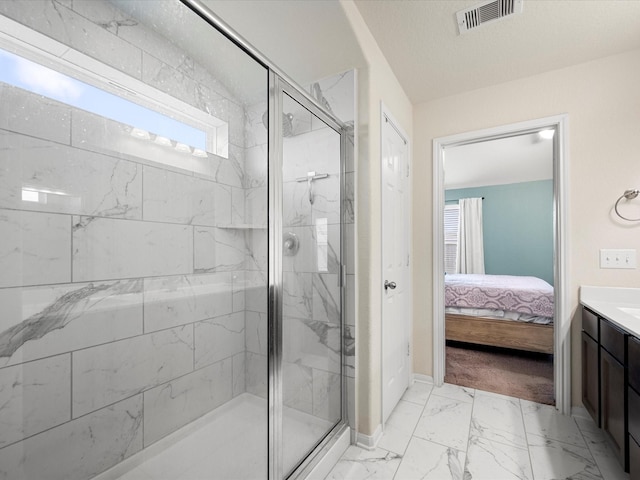 ensuite bathroom with visible vents, vanity, marble finish floor, a marble finish shower, and ensuite bath