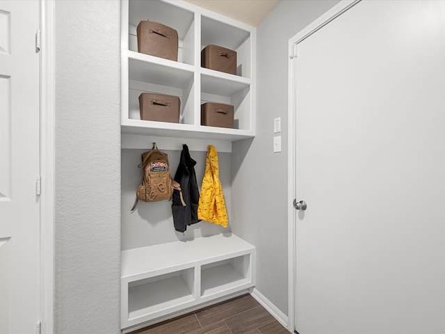 mudroom featuring baseboards and wood finish floors