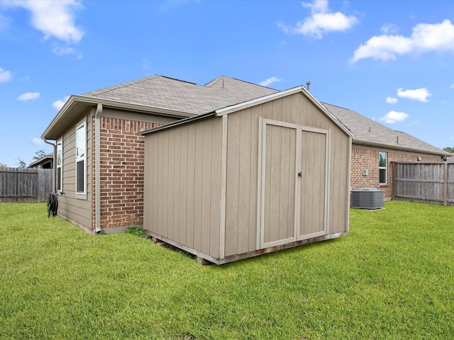 view of shed with a fenced backyard and cooling unit