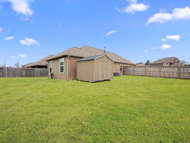 view of yard featuring central AC, a storage unit, an outdoor structure, and a fenced backyard