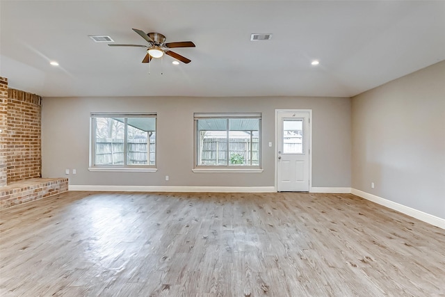 unfurnished living room featuring ceiling fan and light hardwood / wood-style flooring