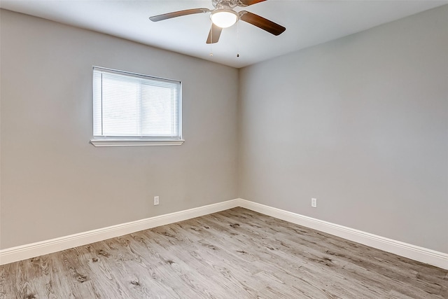 spare room with light wood-type flooring and ceiling fan