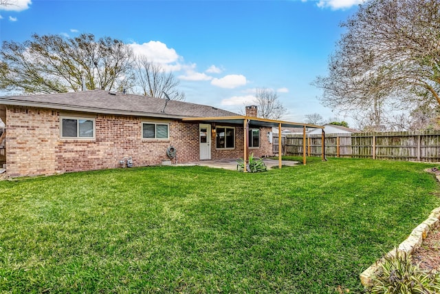 rear view of property with a patio area and a yard