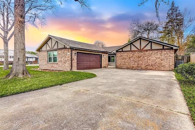 view of front of house featuring a garage and a lawn