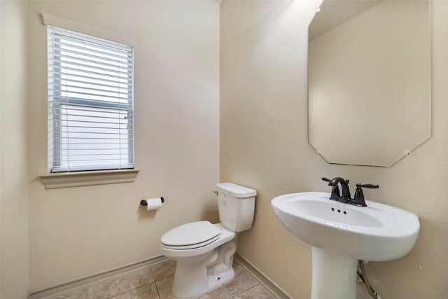 bathroom featuring sink, tile patterned flooring, and toilet