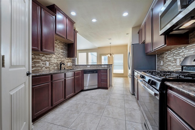 kitchen with decorative light fixtures, appliances with stainless steel finishes, a notable chandelier, and backsplash