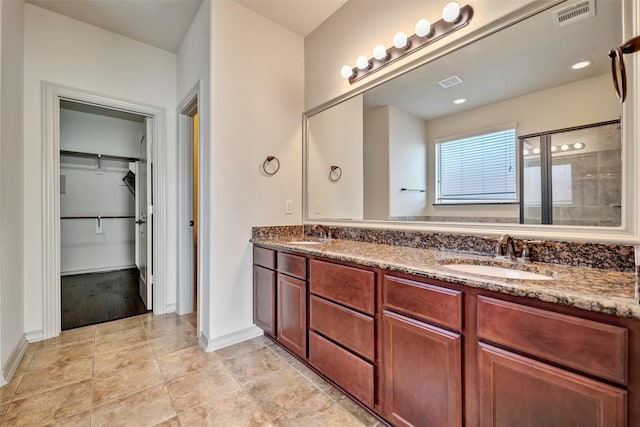 bathroom with walk in shower and vanity