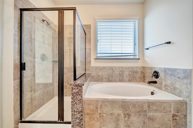 bathroom featuring independent shower and bath