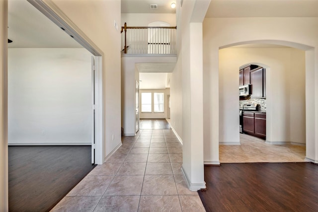 hall featuring light tile patterned floors