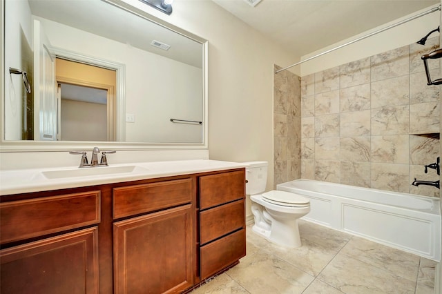 full bathroom featuring toilet, vanity, and tiled shower / bath