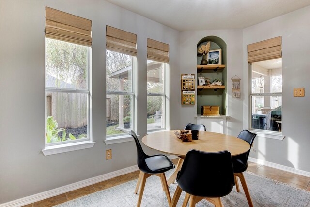 dining space with a healthy amount of sunlight and light tile patterned floors