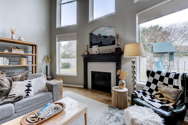 tiled living room featuring a high ceiling