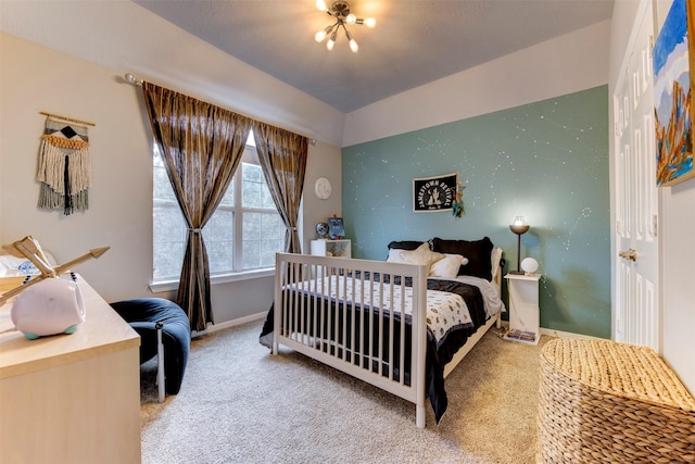 carpeted bedroom with a chandelier