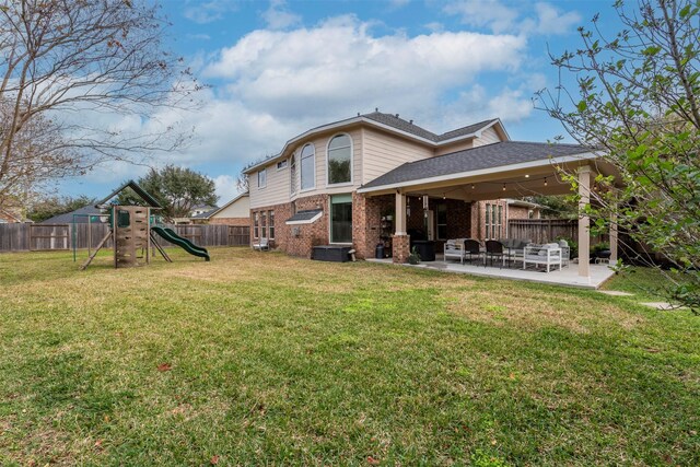 rear view of house with a patio, a playground, and a yard