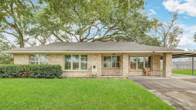 view of front of house with a front yard and a carport